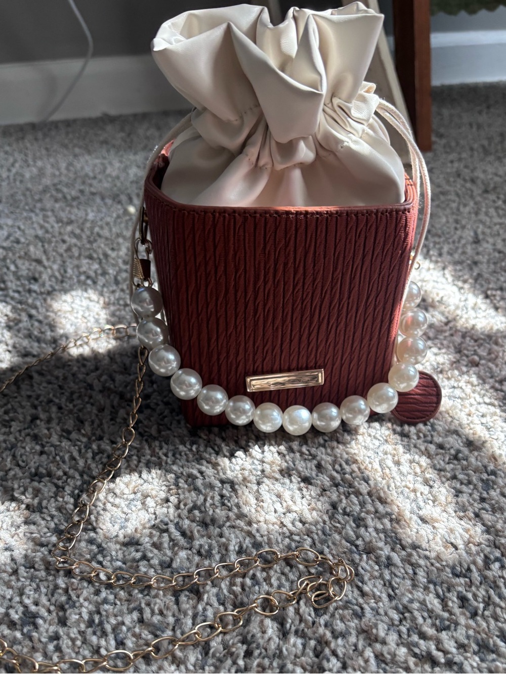 Pearl-Accent Drawstring Crossbody Bag in Burgundy and Cream